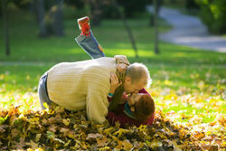 Семейная пара целуется на сухих листьях